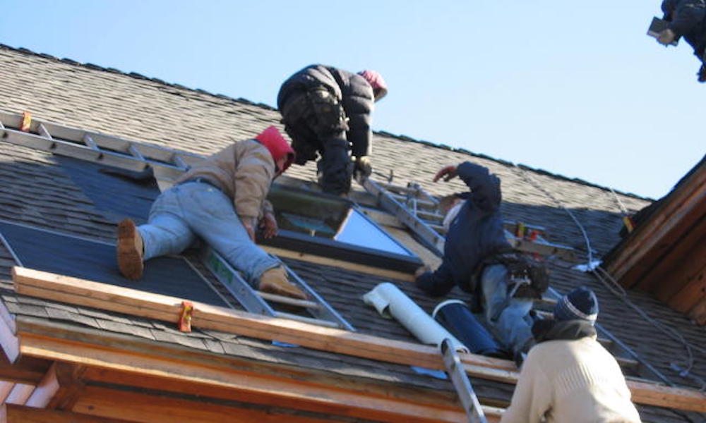Roofers working on a roof correctly, rather than a fast roof replacement in NJ