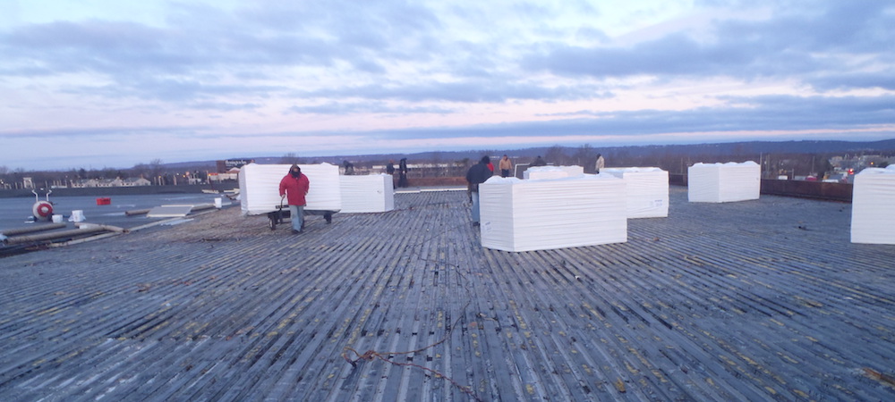 Commercial roofing costs can be mitigated by installing a new roof over an existing structure. 